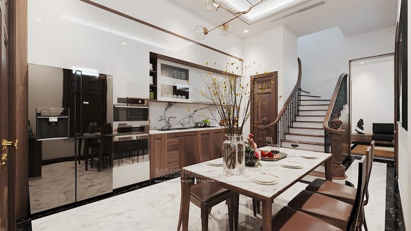 Phòng ăn liền bếp được thiết kế theo phong cách hiện đại với nội thất gỗ óc chó cao cấp giúp tạo nên không gian ấm cúng và thân thiện cho người nội trợ.